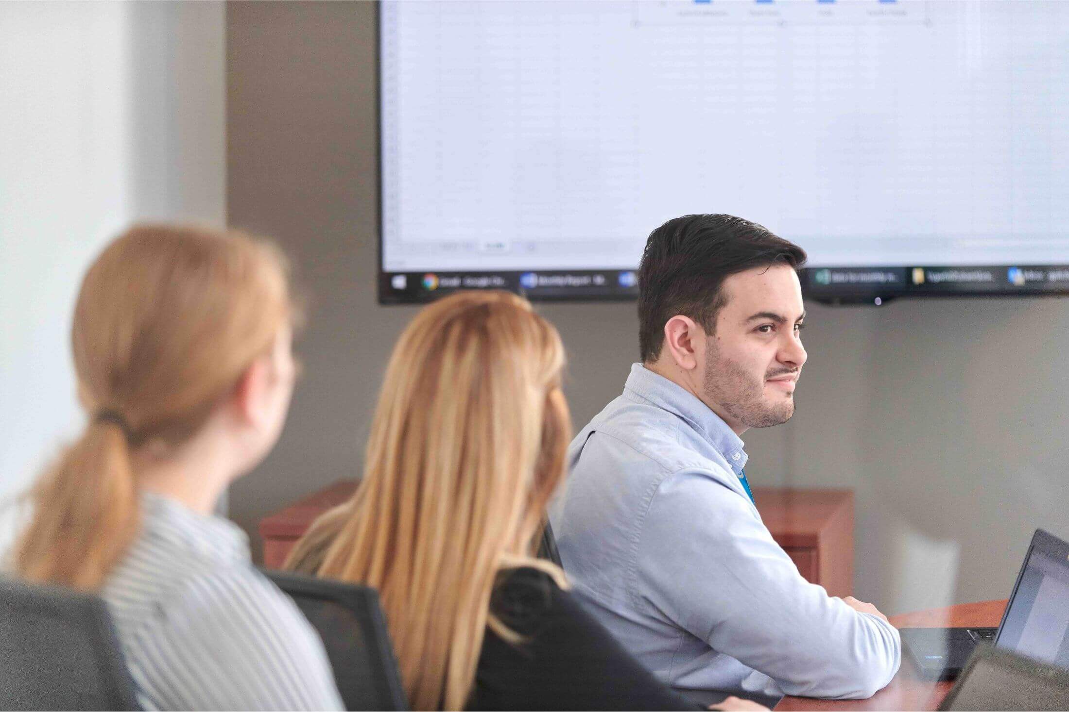 employees seated in front of a presentation