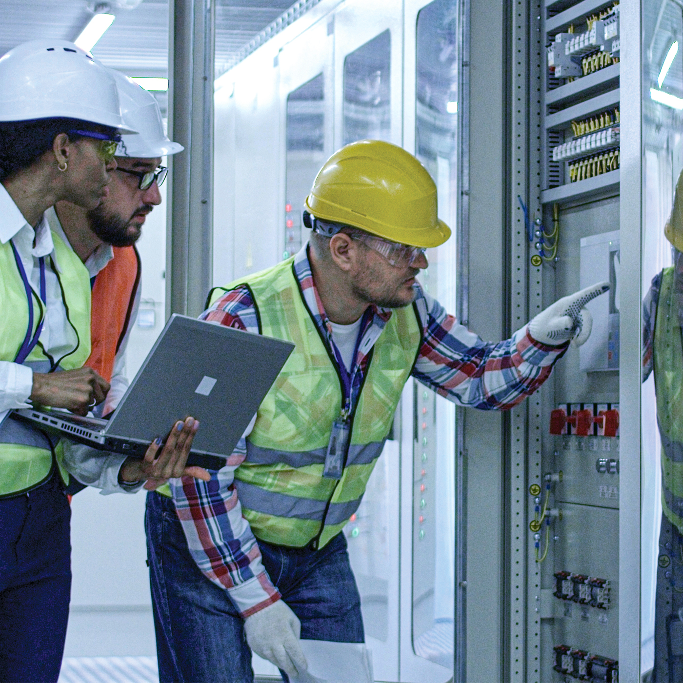 Men looking at a panel.