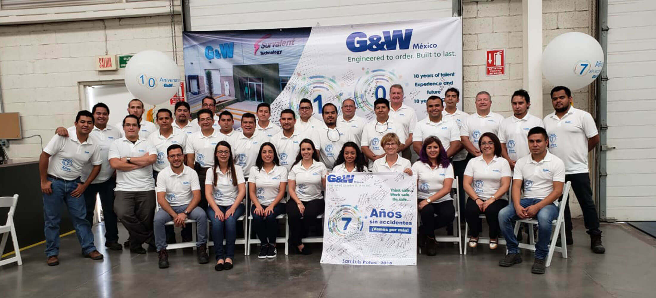 G&W electric group in front of banner