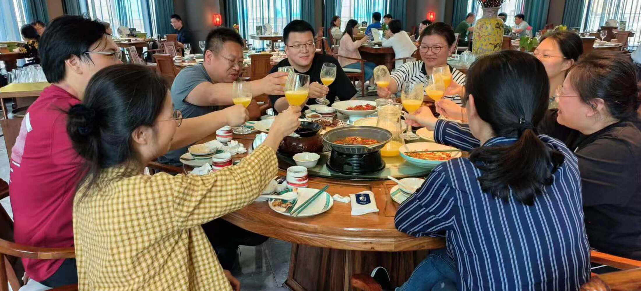 Group doing cheers at dinner in Shanghai